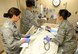 Airmen assigned to the 56th Medical Support Squadron provide medical attention to an injured dummy during the intensive care unit simulation at the Scottsdale Healthcare Military Training Center in Scottsdale, Ariz. The intensive care unit simulation allows Airmen to work together to ensure the stability of an injured patient. (U.S. Air Force photo by Airman 1st Class Alexander Cook)