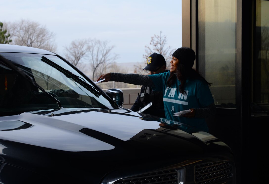 Bernie McFarling, the Sexual Assault Response Coordinator assigned to the 28th Bomb Wing, hands out pamphlets at the Liberty Gate at Ellsworth Air Force Base, S.D.,  March 31, 2017. Ellsworth is scheduled to have a Male Military Sexual Survivor Presentation at the 28th Logistics Readiness Squadron Deployment Center on April 11, 2017, to bring attention to Sexual Assault Awareness and Prevention Month. (U.S. Air Force photo by Airman Nicolas Z. Erwin)