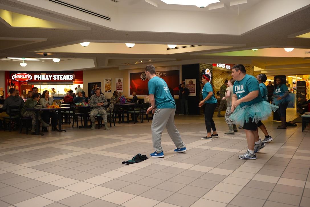 Ellsworth Airmen and civilians watch as Sexual Assault Awareness and Prevention Month volunteers participate in a flash mob dance at the Exchange on Ellsworth Air Force Base, S.D., March 31, 2017. Ellsworth is scheduled to host several SAAPM events to include male victimization awareness training to bring attention to male victims of sexual assault. (U.S. Air Force photo by Airman Nicolas Z. Erwin)