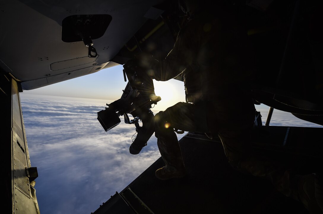 A special missions aviator with the 8th Special Operations Squadron, scans the horizon from a CV-22 Osprey over Northwest Florida, April 3, 2017. The aircrew visited Duke Field to utilize a Landing Helicopter Deck as part of a pre-deployment requirement for CV-22 aircrew to be deck qualified. The LHD will serve as part of the aircraft carrier qualification, decreasing the amount of time 8th SOS and 8th Aircraft Maintenance Unit personnel spend off station to fulfill the requirement.(U.S. Air Force photo by Airman 1st Class Joseph Pick)