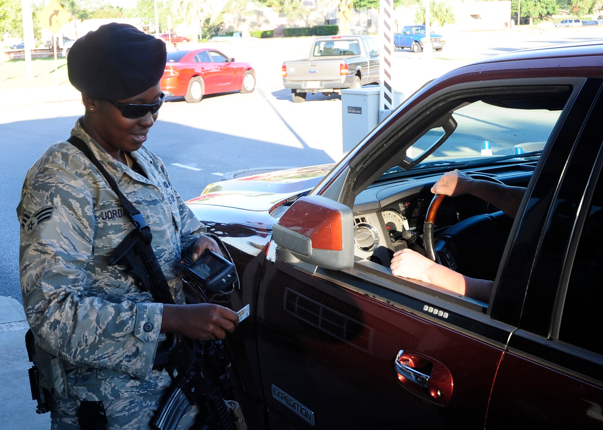 U.S. Air Force Senior Airman Nichole Jordan, 325th Security Forces Squadron base defense operation center controller, checks the credentials of a visitor entering Tyndall Air Force Base, Fla., Sept. 14, 2015. Security Forces members like Jordan will be an integral part of safety and security during the 2017 Gulf Coast Salute air show and open house. (U.S. Air Force photo by Senior Airman Solomon Cook/Released)