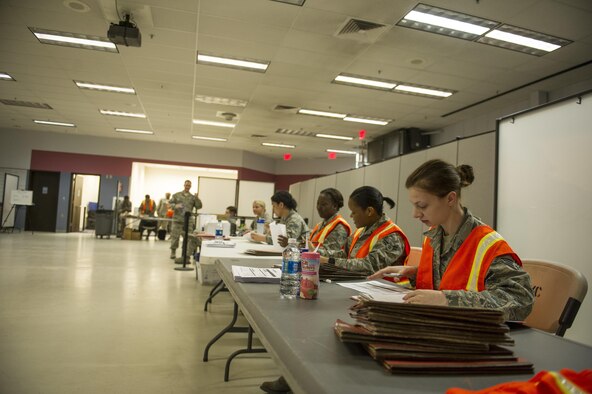 U.S. Airman 1st Class Chelsea Walters, a 354th Force Support Squadron force management apprentice, checks the mobility folders of Airmen who are simulated deploying in support of exercise Arctic Gold (AG) 17-5, April 4, 2017, at Eielson Air Force Base, Alaska. AG 17-5 is an exercise which aims to simulate execution of a specific Operation Plan. (U.S. Air Force photo by Airman 1st Class Isaac Johnson)