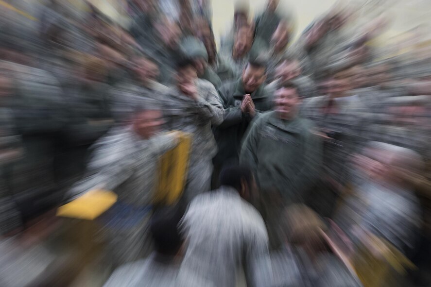 Yokota maintainers cheer competitors during the annual 374th Maintenance Group wrenchbender rodeo chock hold competition at Yokota Air Base, Japan, March 31, 2017. Yokota maintainers with the 374th Aircraft Maintenance Squadron, 374th Maintenance Squadron, 374th MXG, and 730th Air Mobility Squadron teamed up and participated in the rodeo which a variety of challenges: four-man pushups, leadership tool identification, maintenance relay race, Self Aid Buddy Care (SABC) timed event, vehicle push, towbar obstacle course, chock hold, blindfolded toolbox buildup, and a C-130 pull event. (U.S. Air Force photo by Yasuo Osakabe)  