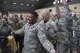 Senior Airman Quentin Gartrell, 374th Maintenance Group document specialist, laughs as he wins the competition during the annual 374th Maintenance Group wrenchbender rodeo chock hold competition at Yokota Air Base, Japan, March 31, 2017. The chock hold competition challenged Airmen to endure holding chocks up longer than opposing teams. A chock is a wedge placed against a wheel to prevent an aircraft from movement. (U.S. Air Force photo by Yasuo Osakabe)