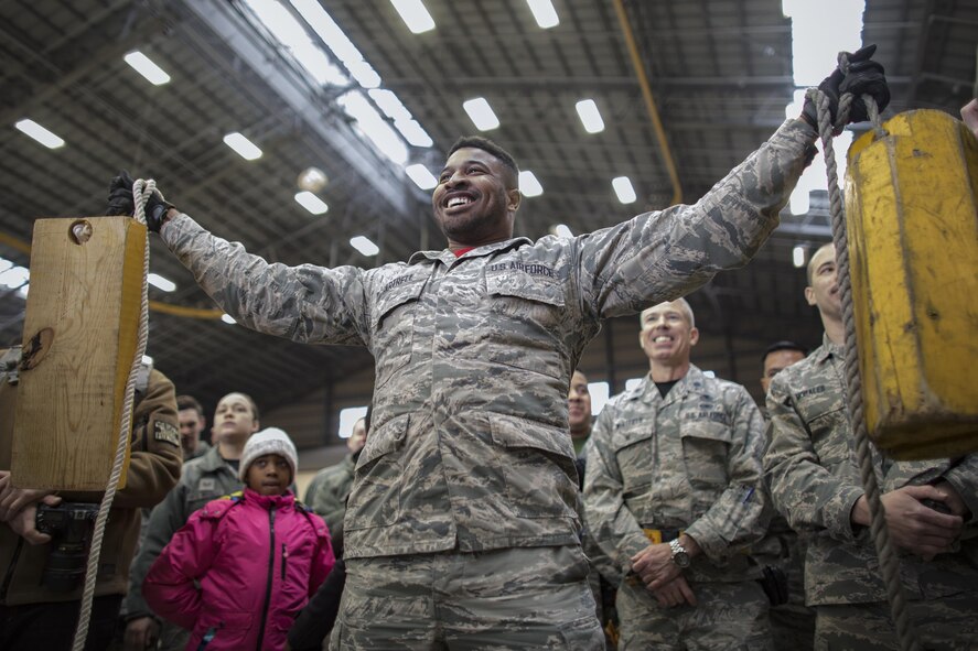 Senior Airman Quentin Gartrell, 374th Maintenance Group document specialsit, holds chocks up during the annual 374th MXG Wrenchbender rodeo chock hold competition at Yokota Air Base, Japan, March 31, 2017. Gartrell is one of the finalist of the competition. The chock hold competition challenged Airmen to endure holding chocks up longer than opposing teams. A chock is a wedge placed against a wheel to prevent an aircraft from movement. (U.S. Air Force photo by Yasuo Osakabe)