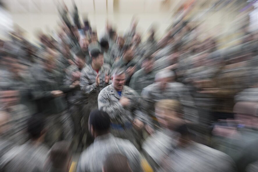Lt. Col. Todd Wydra, 515th Air Mobility Operations Group deputy commander, poses after completing the chock hold competition during the annual 374th Maintenance Group wrenchbender rodeo at Yokota Air Base, Japan, March 31, 2017. The chock hold competition challenged Airmen's endurance and the winners were determined by their ability to hold chocks up longer than their opponents. A chock is a wedge placed against a wheel to prevent an aircraft from movement. (U.S. Air Force photo by Yasuo Osakabe)