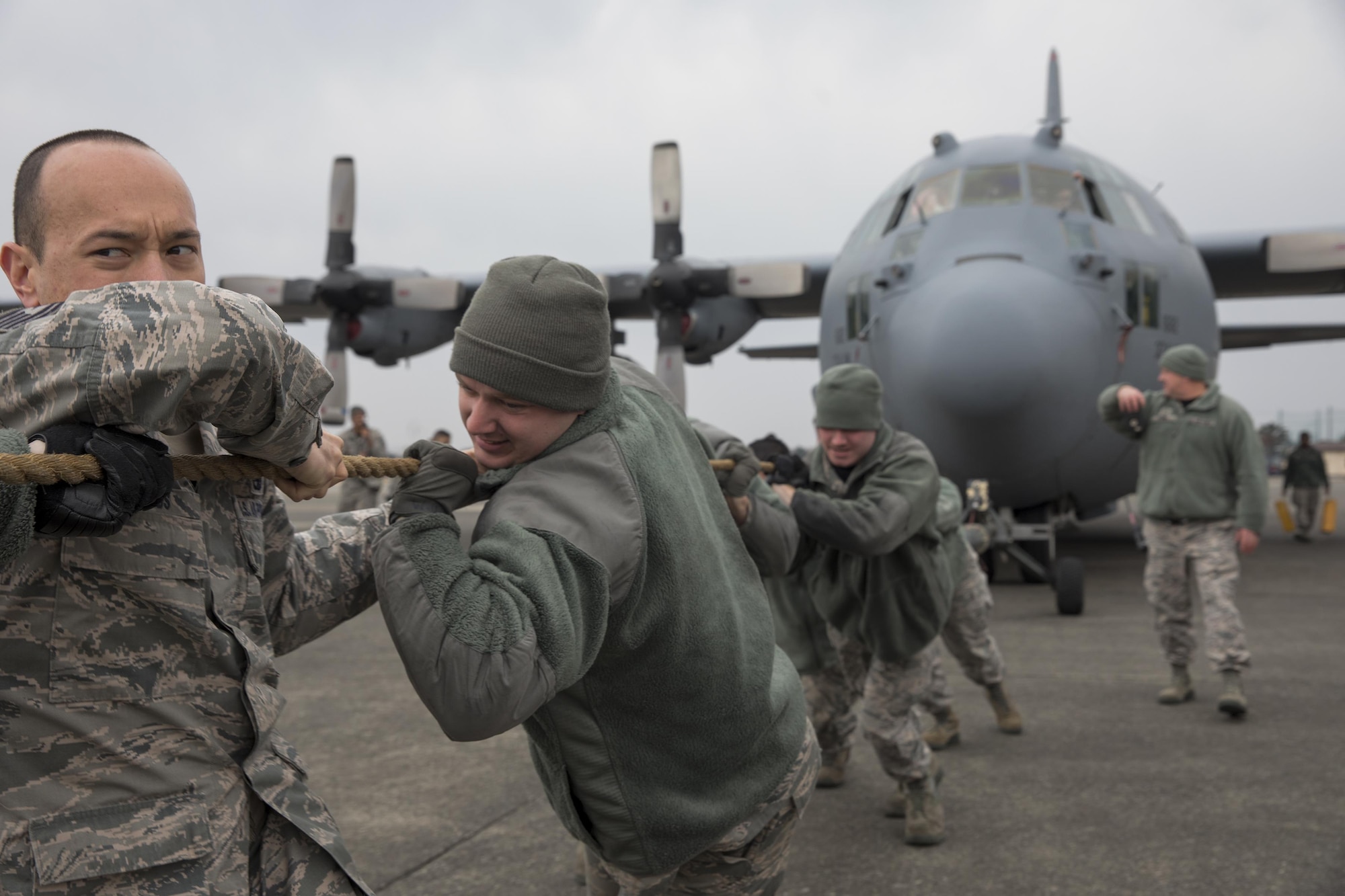 Member with the 374th Aircraft Maintenance Group pull a C-130H Hercules at Yokota Air Base, Japan, March 31, 2017. The aircraft was pulled as part of the 374th Maintenance Group Rodeo Competition which puts squadrons against each other in various tasks to win points toward an award and a year's worth of bragging rights. (U.S. Air Force photo by Yasuo Osakabe)
