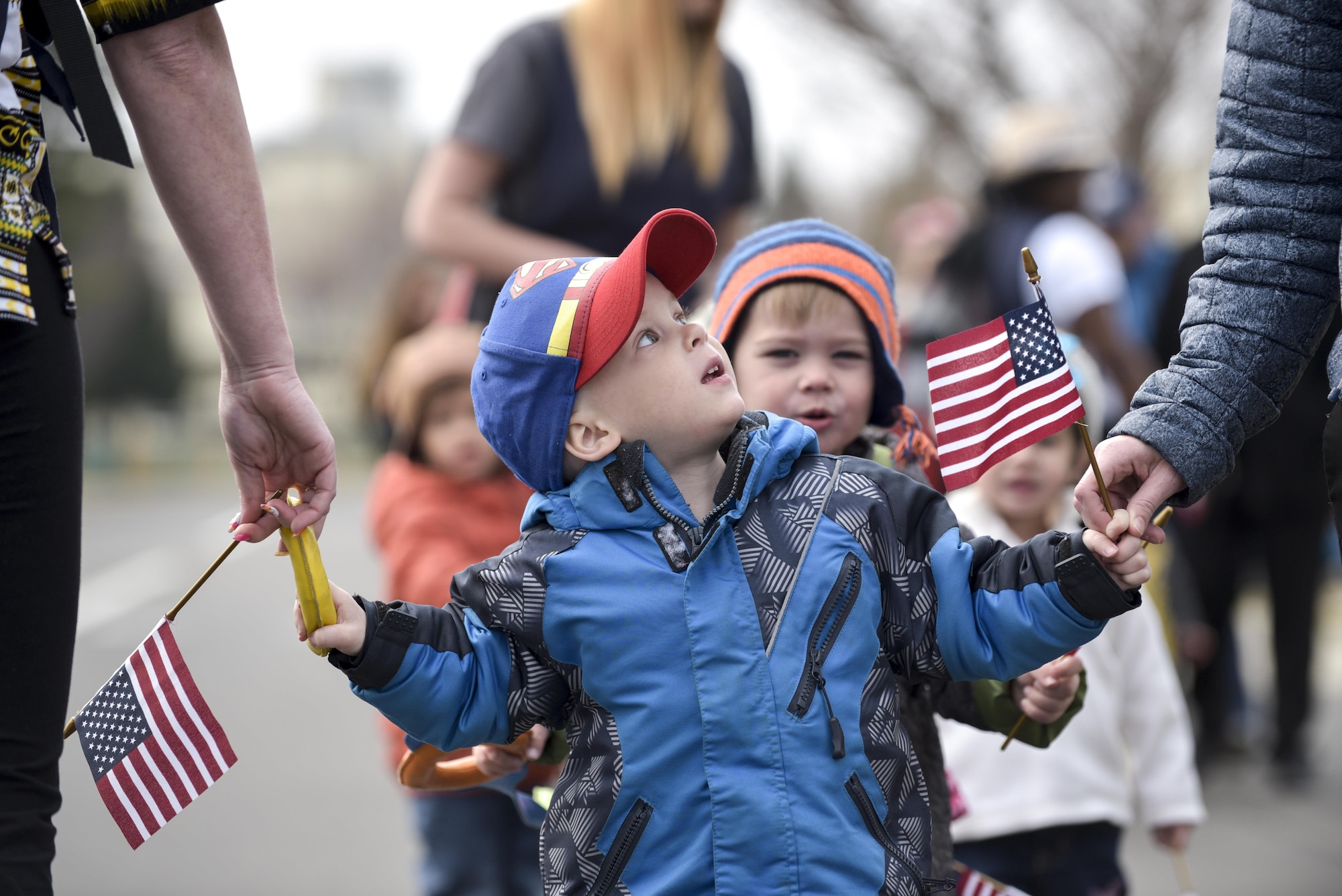 A young boy looks at his mom during the Month of the Military Child parade at Misawa Air Base, Japan, April 3, 2017. The parade was the kick-off for the month long event that includes various spirit and themed days. (U.S. Air Force photo by Staff Sgt. Melanie A. Hutto)