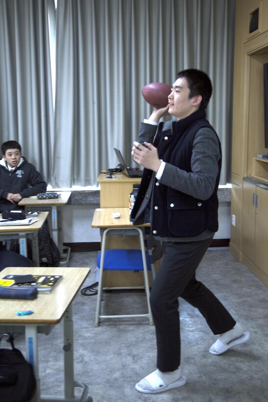 A student at Ocheon high school throws a football May 30 during an American culture class in Pohang, South Korea. Marines and sailors withCombat Logistics detachment 333, Combat Logistics Battalion 4, Combat Logistics Regiment 3, 3rd Marine Logistics Group, III Marine Expeditionary Force, led classes on American sports, hobbies and music while working with students to improve their English skills. The service members spent a week at the school to ensure all the students had an opportunity to talk with them. (U.S. Marine Corps photo by Cpl. Jessica Collins)