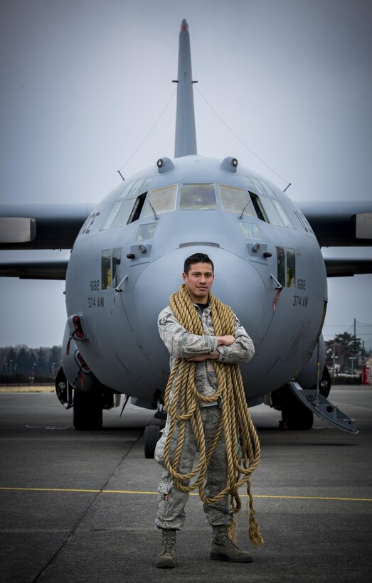 Airman 1st Class Roberto A. Pena, 374th Aircraft Maintenance Squadron electrical and environmental apprentice, stands in front of a C0130H Hercules with a rope wrapped around his neck that was used by participants in the C-130 pull event during the 374th Maintenance Group Wrenchbender Rodeo March 31, 2017, at Yokota Air Base, Japan. Teams from various maintenance squadrons competed against each other in nine events including: 4-man push-ups, vehicle push, blindfolded toolbox buildup, maintenance relay, tow bar obstacle course, leadership tool identification, chock hold, Self-Aid and Buddy Care relay and finished with a C-130 pull. (U.S. Air Force photo by Airman 1st Class Donald Hudson)