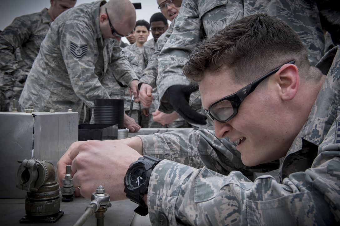 An Airman participates in a timed safety wire installation as part of a maintenance relay race during the 374th Maintenance Group Wrenchbender Rodeo March 31, 2017, at Yokota Air Base, Japan. The MX Rodeo is a morale event and allows for friendly competition between the various maintenance squadrons on base. (U.S. Air Force photo by Airman 1st Class Donald Hudson)