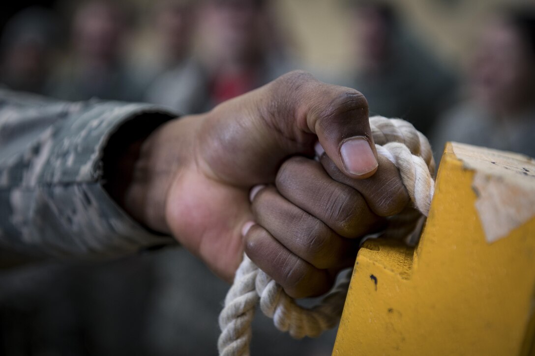 An Airmen grips the rope of a chock during the chock hold event in the 374th Maintenance Group Wrenchbender Rodeo March 31, 2017, at Yokota Air Base, Japan. The Rodeo consisted of four teams of 42 Airmen from the 374 Maintenance Group, 374th Aircraft Maintenance Squadron, 374th Maintenance Squadron and the 730th Air Mobility Squadron. (U.S. Air Force photo by Airman 1st Class Donald Hudson)