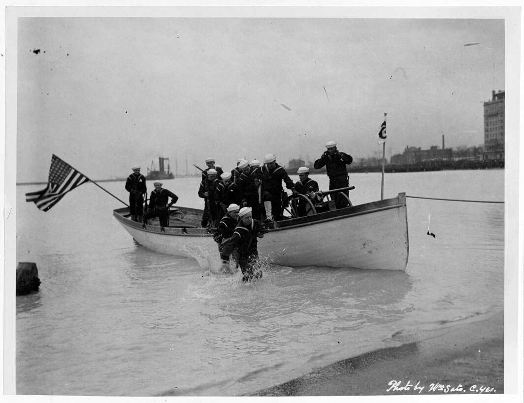 Sailors conduct landing-party training using a rowing launch and one-pounder gun on a field carriage at Great Lakes Naval Training Station, Ill., 1918. Navy photo by Chief Yeoman William Sato