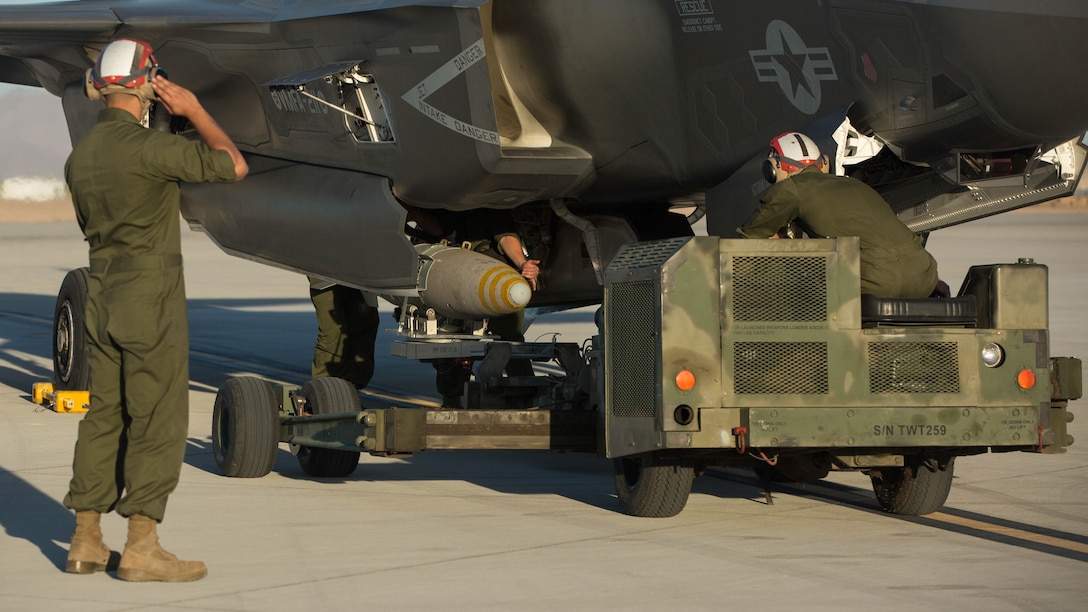 Marines with VMFA-211 and U.S. Marines with Marine Aviation Weapons and Tactics Squadron One (MAWTS-1) conduct a hot load on the F-35B Lightning II during Weapons and Tactics Instructor Course (WTI) 2-17 at Marine Corps Air Station Yuma, Ariz., April 4, 2017. The ordnance loading exercise focused on loading the aircraft while the pilot is onboard and the engine is running which provides the Marine Corps with a capability to project Marine air power forward on the battlefield while decreasing aircraft turnaround time and increasing sortie generation.