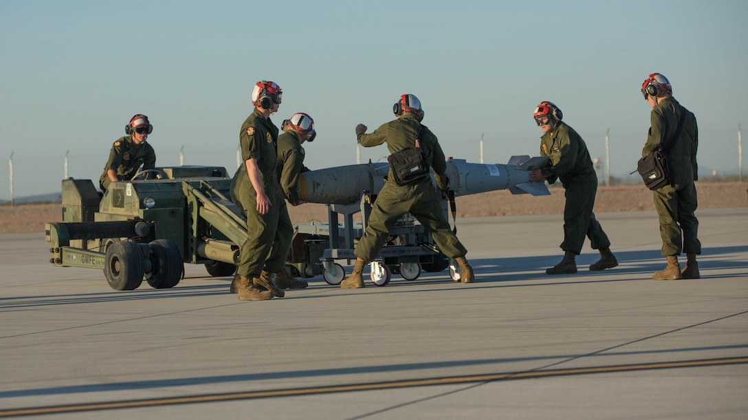 Marines with VMFA-211 and U.S. Marines with Marine Aviation Weapons and Tactics Squadron One (MAWTS-1) conduct a hot load on the F-35B Lightning II during Weapons and Tactics Instructor Course (WTI) 2-17 at Marine Corps Air Station Yuma, Ariz., April 4, 2017. The ordnance loading exercise focused on loading the aircraft while the pilot is onboard and the engine is running which provides the Marine Corps with a capability to project Marine air power forward on the battlefield while decreasing aircraft turnaround time and increasing sortie generation. 