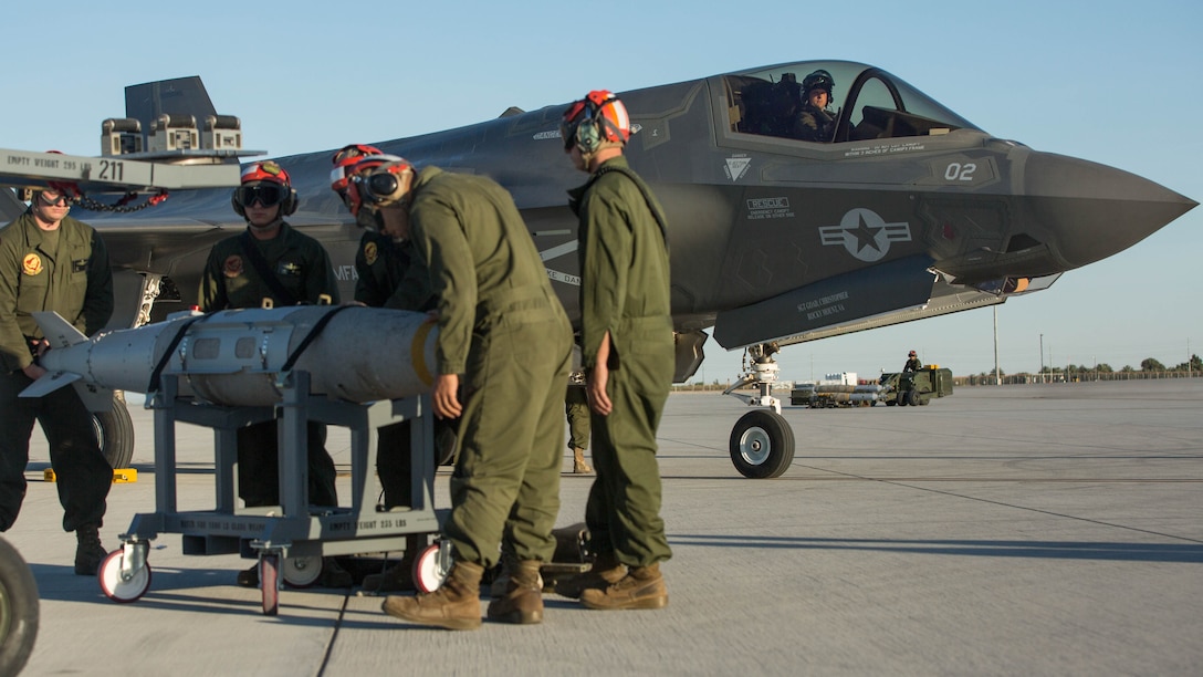 Marines with VMFA-211 and U.S. Marines with Marine Aviation Weapons and Tactics Squadron One (MAWTS-1) conduct a hot load on the F-35B Lightning II during Weapons and Tactics Instructor Course (WTI) 2-17 at Marine Corps Air Station Yuma, Ariz., April 4, 2017. The ordnance loading exercise focused on loading the aircraft while the pilot is onboard and the engine is running which provides the Marine Corps with a capability to project Marine air power forward on the battlefield while decreasing aircraft turnaround time and increasing sortie generation.