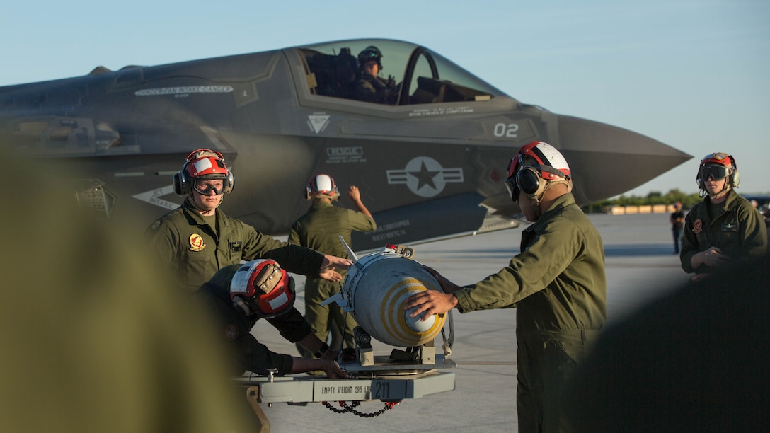 Marines with VMFA-211 and U.S. Marines with Marine Aviation Weapons and Tactics Squadron One (MAWTS-1) conduct a hot load on the F-35B Lightning II during Weapons and Tactics Instructor Course (WTI) 2-17 at Marine Corps Air Station Yuma, Ariz., April 4, 2017. The ordnance loading exercise focused on loading the aircraft while the pilot is onboard and the engine is running which provides the Marine Corps with a capability to project Marine air power forward on the battlefield while decreasing aircraft turnaround time and increasing sortie generation.