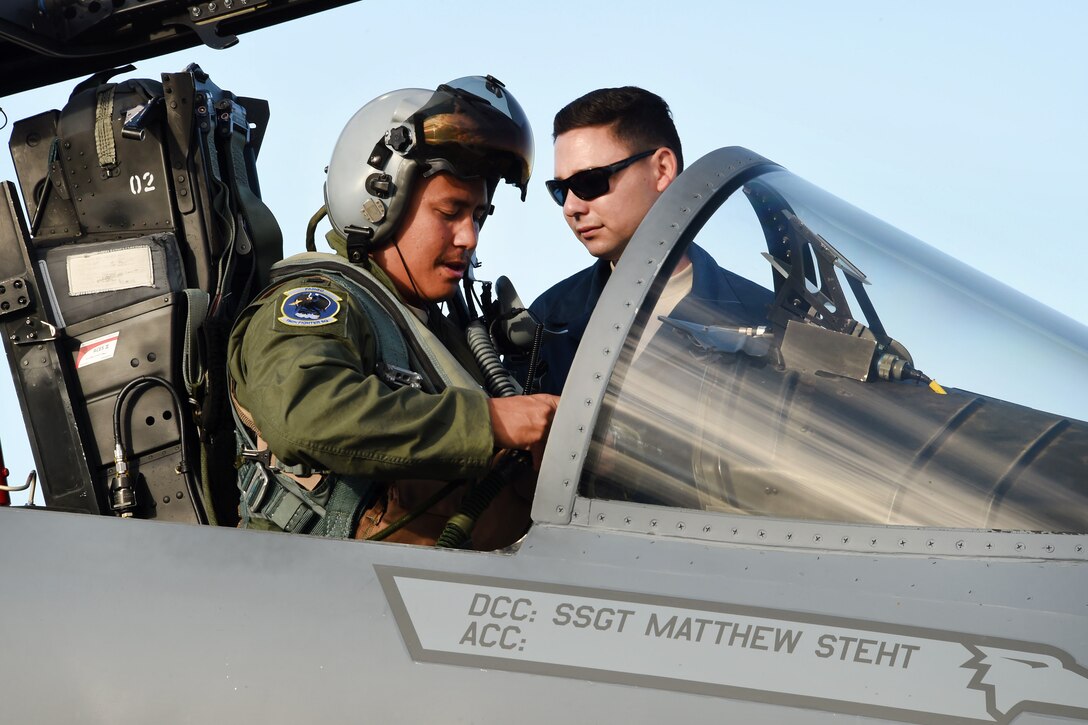 California Air National Guard Capt. Christopher Lacroix, left, performs preflight checks in an F-15C Eagle. He is assisted by Staff Sgt. Michael Pruitt during exercise Sentry Aloha 17-03 at Joint Base Pearl Harbor-Hickam, Hawaii, March 30, 2017. Lacroix is a pilot assigned to the California Air National Guard’s 194th Fighter Squadron. Pruitt is a crew chief assigned to the California Air National Guard’s 44th Aircraft Maintenance Squadron. Sentry Aloha is an Air Guard-led exercise that provides a current, realistic, and integrated training environment to the U.S. Air Force and joint partners. Air National Guard photo by Senior Master Sgt. Chris Drudge