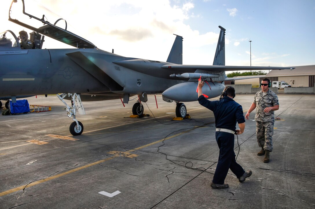 California Air National Guard Staff Sgt. Michael Pruitt, left, and Senior Airman Chris Gaal perform preflight checks on an F-15C Eagle as Capt. Christopher Lacroix observes from the cockpit during Sentry Aloha 17-03 at Joint Base Pearl Harbor-Hickam, Hawaii, March 30, 2017. Pruitt and Gaal are crew chiefs assigned to the California Air National Guard’s 44th Aircraft Maintenance Squadron. Lacroix is a pilot assigned to the California Air National Guard’s 194th Fighter Squadron. Air National Guard photo by Senior Master Sgt. Chris Drudge