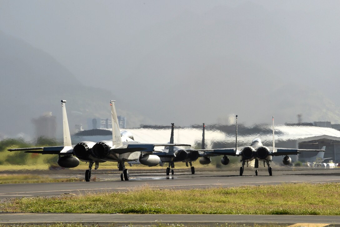 Three F-15 Eagle aircraft taxi before a morning sortie during exercise Sentry Aloha 17-03 at Joint Base Pearl Harbor-Hickam, Hawaii, March 30, 2017. Air National Guard photo by Senior Master Sgt. Chris Drudge