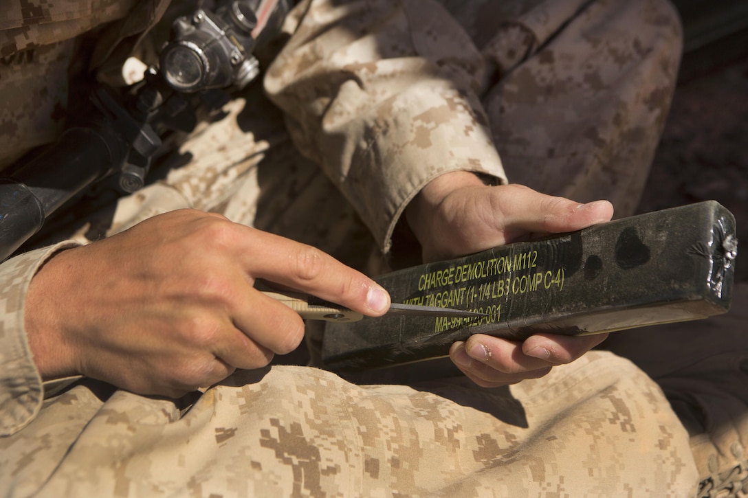 A Marine prepares an M112 demolition charge to be used during Talon Exercise 2-17, at Yuma, Arizona, March 30, 2017. The Marine is assigned to 2nd Battalion, 6th Marine Regiment. The training was for ground combat units to conduct integrated training in support of the Weapons and Tactics Instructor Course 2-17, hosted by Marine Aviation Weapons and Tactics Squadron 1. Marine Corps photo by Lance Cpl. Santino D. Martinez