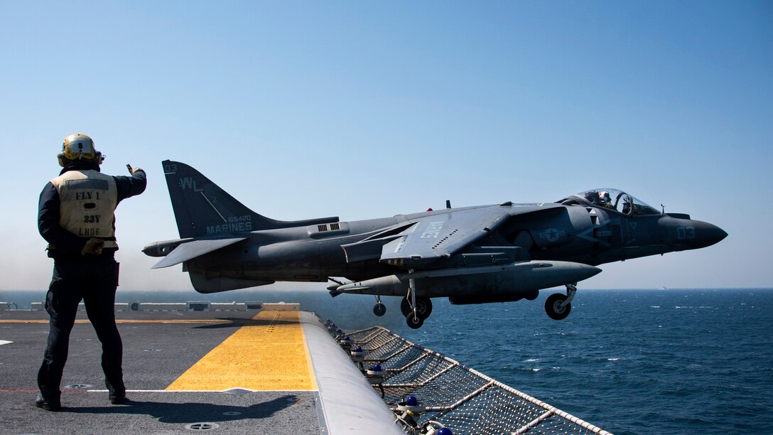 Aviation Boatswain's Mate Airman Matthew Titus, from St. Louis, Mo., directs the launch of an AV-8B Harrier, assigned to the Tomcats of Marine Attack Squadron 311, from the flight deck of the amphibious assault ship USS Bonhomme Richard, April 3, 2017. Bonhomme Richard, flagship of the Bonhomme Richard Expeditionary Strike Group, with embarked 31st Marine Expeditionary Unit, is on a routine patrol, operating in the Indo-Asia-Pacific region to enhance warfighting readiness and posture forward as a ready-response force for any type of contingency.