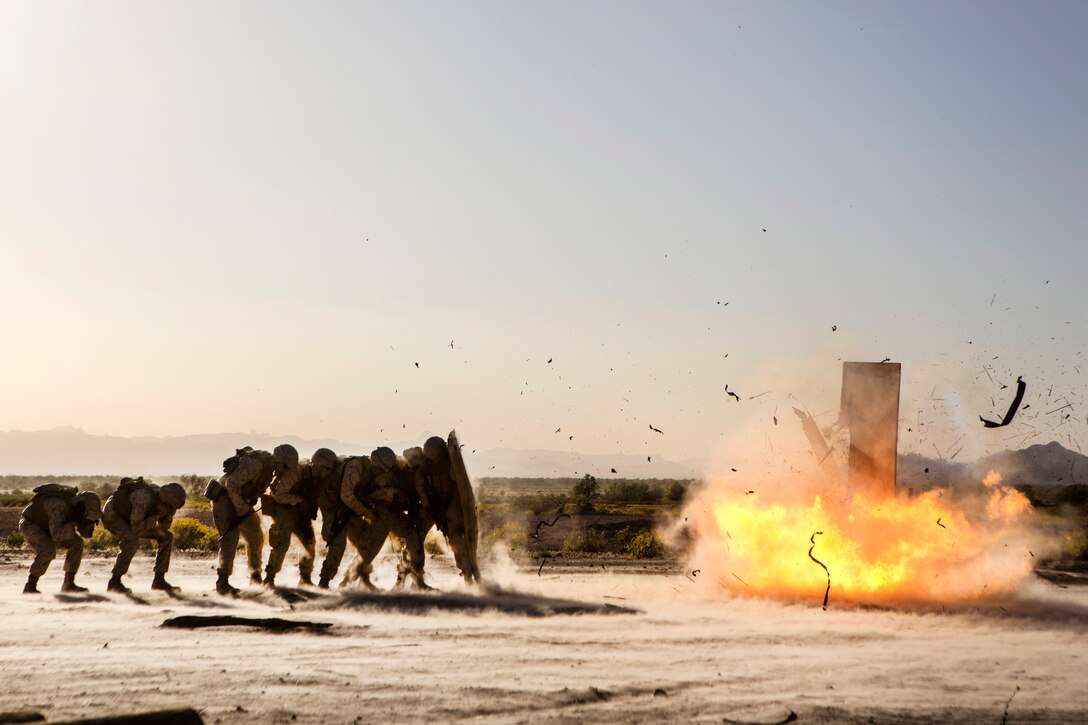 Marines take cover behind a blast blanket while conducting urban demolition breach training during Talon Exercise 2-17, at Yuma, Arizona, March 30, 2017. The Marines are assigned to 2nd Battalion, 6th Marine Regiment and 2nd Combat Engineer Battalion. Marine Corps photo by Lance Cpl. Santino D. Martinez
