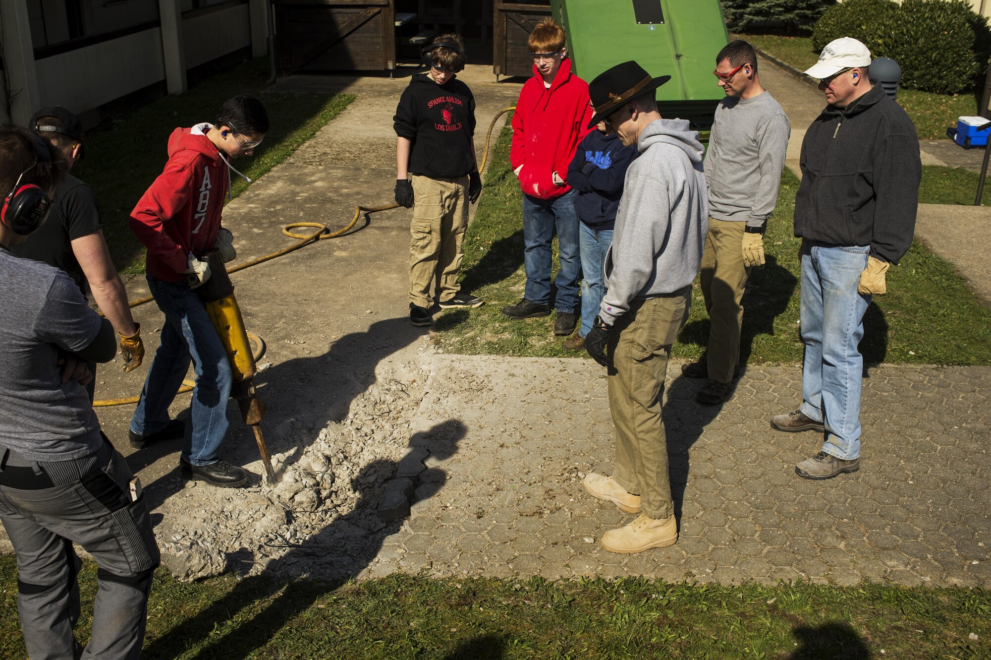 Ka'eo Swartzmiller, Eagle Scout candidate with Scout Troop 165 operates a jackhammer during a community service project on Spangdahlem Air Base, Germany, March 25, 2016. Swartzmiller Eagle Scout project consists of widening the sidewalk, refurbishing the chapel gazebo and adding a concrete pad for the nativity scene. (U.S. Air Force photo by Staff Sgt. Jonathan Snyder)
