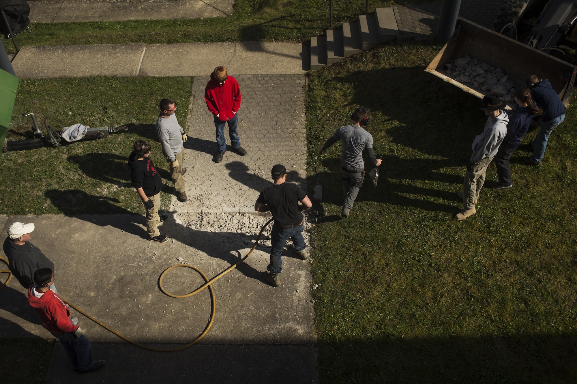 Scout Troop 165 works on removing the old side walk during a community service project with Ka'eo Swartzmiller, Eagle Scout candidate, on Spangdahlem Air Base, Germany, March 25, 2016. Swartzmiller Eagle Scout project consists of widening the sidewalk, refurbishing the chapel gazebo and adding a concrete pad for the nativity scene. (U.S. Air Force photo by Staff Sgt. Jonathan Snyder)