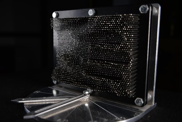 A prototype of the Actuated Pin Antenna Reflector is displayed. Capt. Daniel Stambovsky, a physicist assigned to the 32nd Intelligence Squadron at Fort Meade, Maryland, designed the prototype during his previous assignment at the Air Force Research Laboratory in Rome, New York. (U.S. Air Force photo/Staff Sgt. Alexandre Montes)