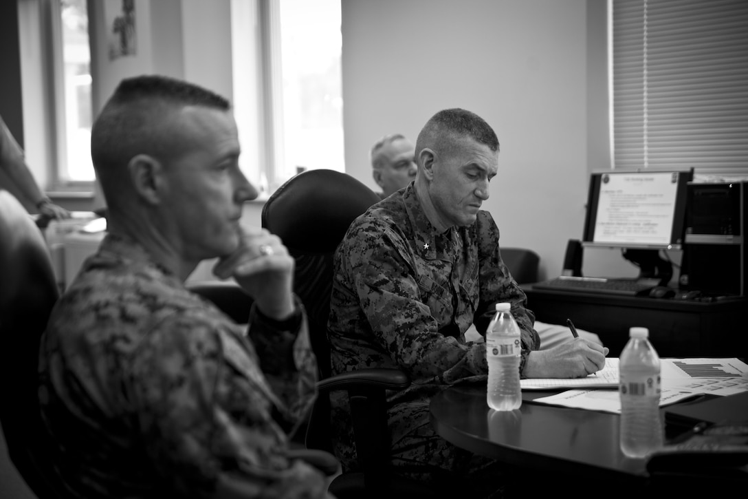 U.S. Marine Corps Col. David P. Grant, left, commanding officer of Marine Corps Combat Service Support Schools (MCCSSS), and Brig. Gen. Jason Q. Bohm, commanding general of Training Command, recieve a brief from Train the Trainer School during Bohm's visit to Camp Johnson, N.C., March 1, 2017. Brig. Gen. Bohm's visit was to observe and discuss how MCCSSS' plans nest with the Training Command Campaign Plan and to review progress on the Leadership Development Program, reading and writing programs, and employment of Force Fitness Instructors. (U.S. Marine Corps photo by Cpl. Laura Mercado)