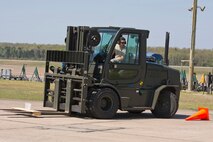 U.S. Air Force Reserve Tech Sgt. Danny Canup, air transportation craftsman, 96th Aerial Port Squadron, notices a flaw while operating a forklift during the Unit Training Assembly weekend April 1, 2017, at Little Rock Air Force Base, Ark. The 96 APS team is preparing to compete in the 2017 Port Dawg Challenge for air mobility professionals, and hopes to reclaim their 2012 title of “Top Dawg.” The title refers to the first place trophy. (U.S. Air Force photo by Master Sgt. Jeff Walston/Released)