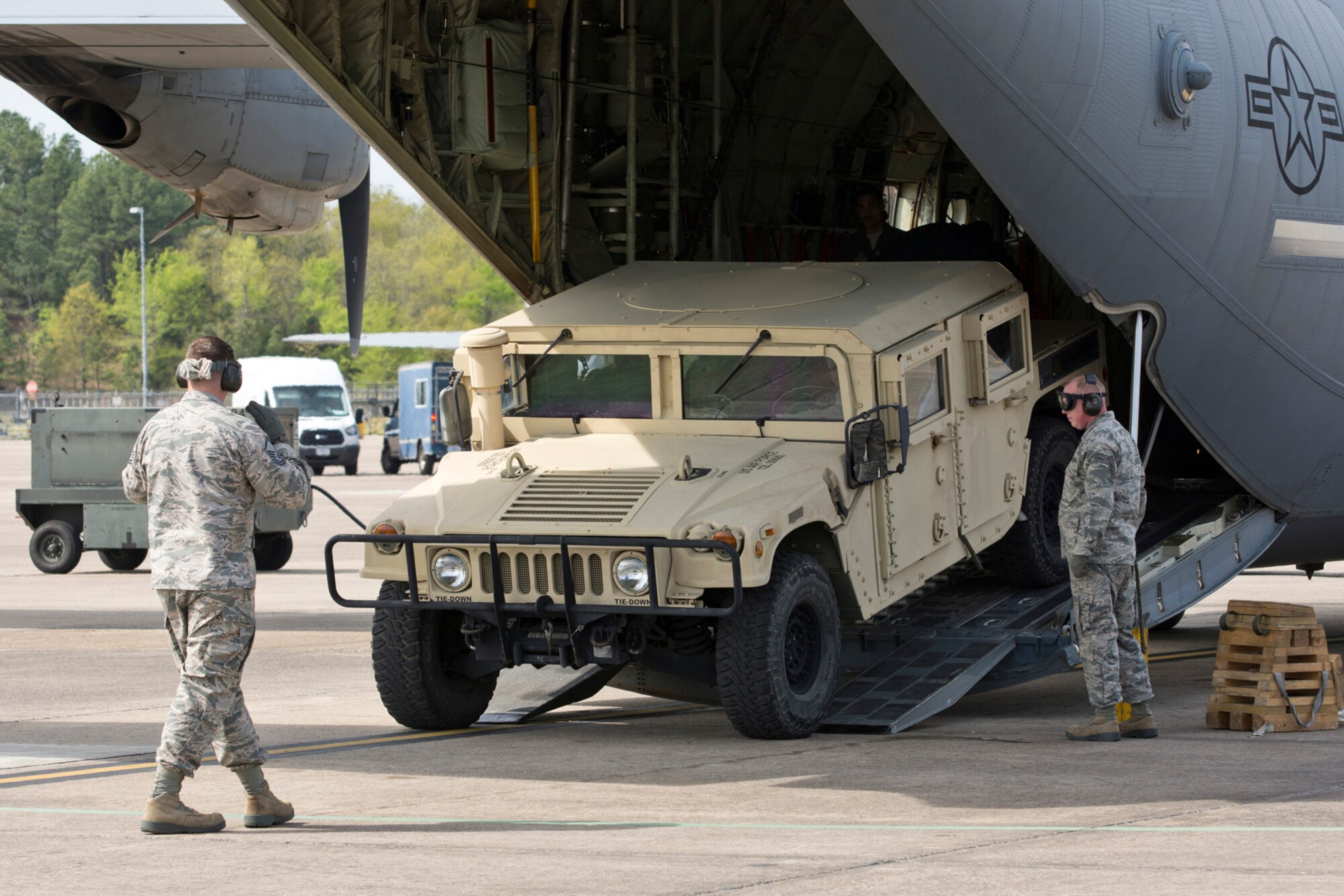 U.S. Air Force Reserve Master Sgt. Morgan Abner, air transportation craftsman, 96th Aerial Port Squadron, directs the driver of a Humvee during a training exercise April 2, 2017, at Little Rock Air Force Base, Ark. Abner is one member of a team preparing to compete in the 2017 Port Dawg Challenge for air mobility professionals, at Dobbins Air Reserve Base, Ga. (U.S. Air Force photo by Master Sgt. Jeff Walston/Released)