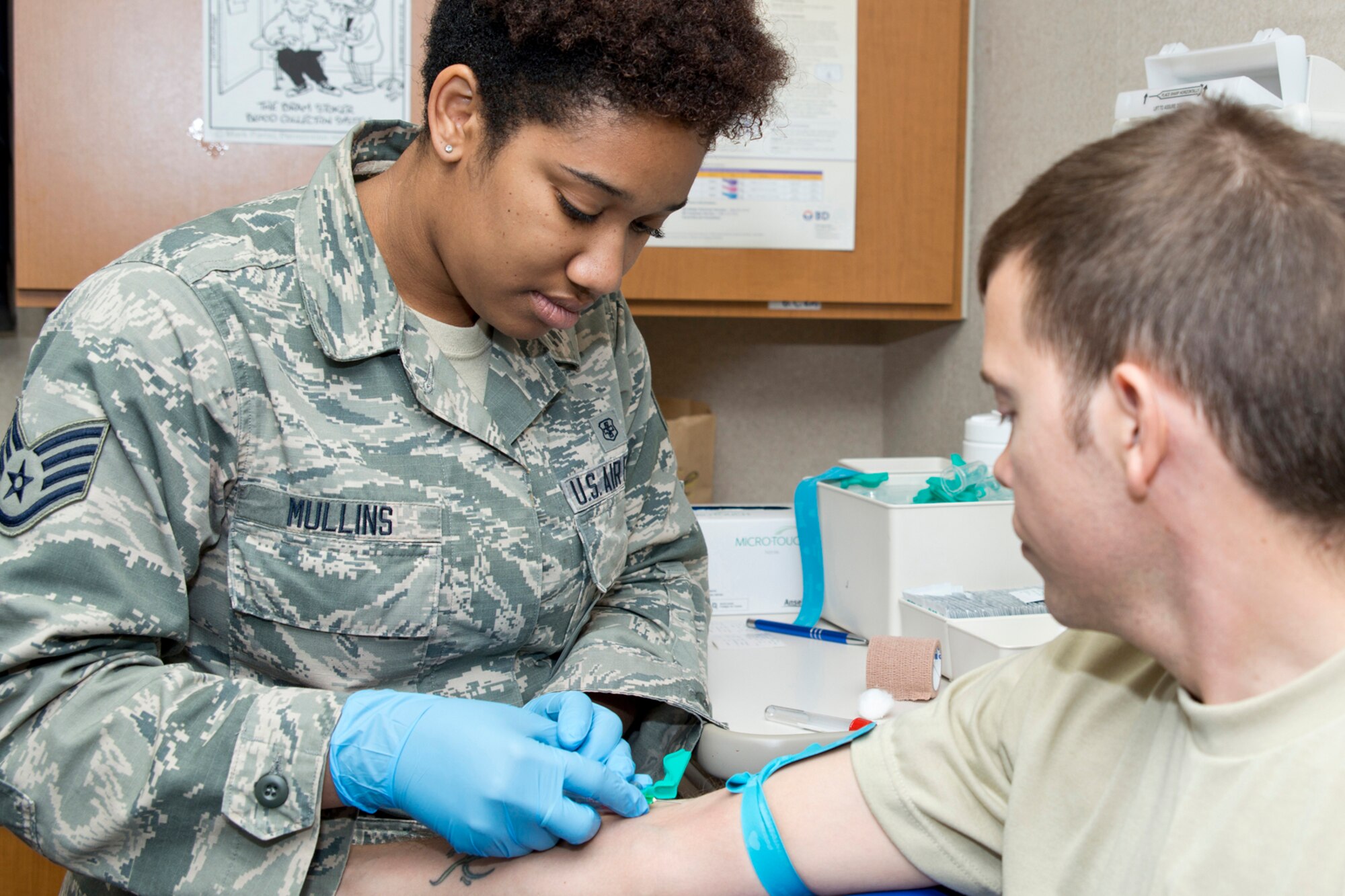 U.S. Air Force Reserve Senior Airman Kyla Mullins, a medical technician assigned to the 913th Aerospace Medical Squadron, draws blood from Tech Sgt. Jimmy McDougall, a 913th Maintenance Squadron crew chief, for annual readiness labs during the Unit Training Assembly weekend April 1, 2017, at Little Rock Air Force Base, Ark. These laboratory tests are required every year for flyers and medical technicians and every two years for all other 913th Airlift Group personnel. (U.S. Air Force photo by Master Sgt. Jeff Walston/Released)