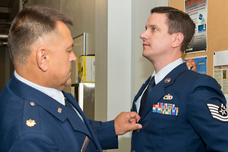 U.S. Air Force Reserve Maj. Jeff Haynes, operations officer, 96th Aerial Port Squadron, checks the ribbons on the uniform of Tech Sgt. Danny Canup, air transportation craftsman, 96 APS, during a uniform inspection April 1, 2017, at Little Rock Air Force Base, Ark. Periodic uniform inspections ensure Airmen maintain the service dress standards. (U.S. Air Force photo by Master Sgt. Jeff Walston/Released)