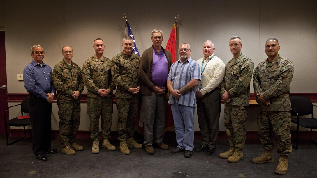 U.S. Marine Corps Brig. Gen. Jason Q. Bohm, commanding general of Training Command, fourth from the left, poses for a photo with civilians and Marines of Marine Corps Combat Service Support Schools (MCCSSS) during his visit to Camp Johnson, N.C., March 1, 2017. Brig. Gen. Bohm's visit was to observe and discuss how MCCSSS' plans nest with the Training Command Campaign Plan and to review progress on the Leadership Development Program, reading and writing programs, and employment of Force Fitness Instructors. (U.S. Marine Corps photo by Cpl. Laura Mercado)