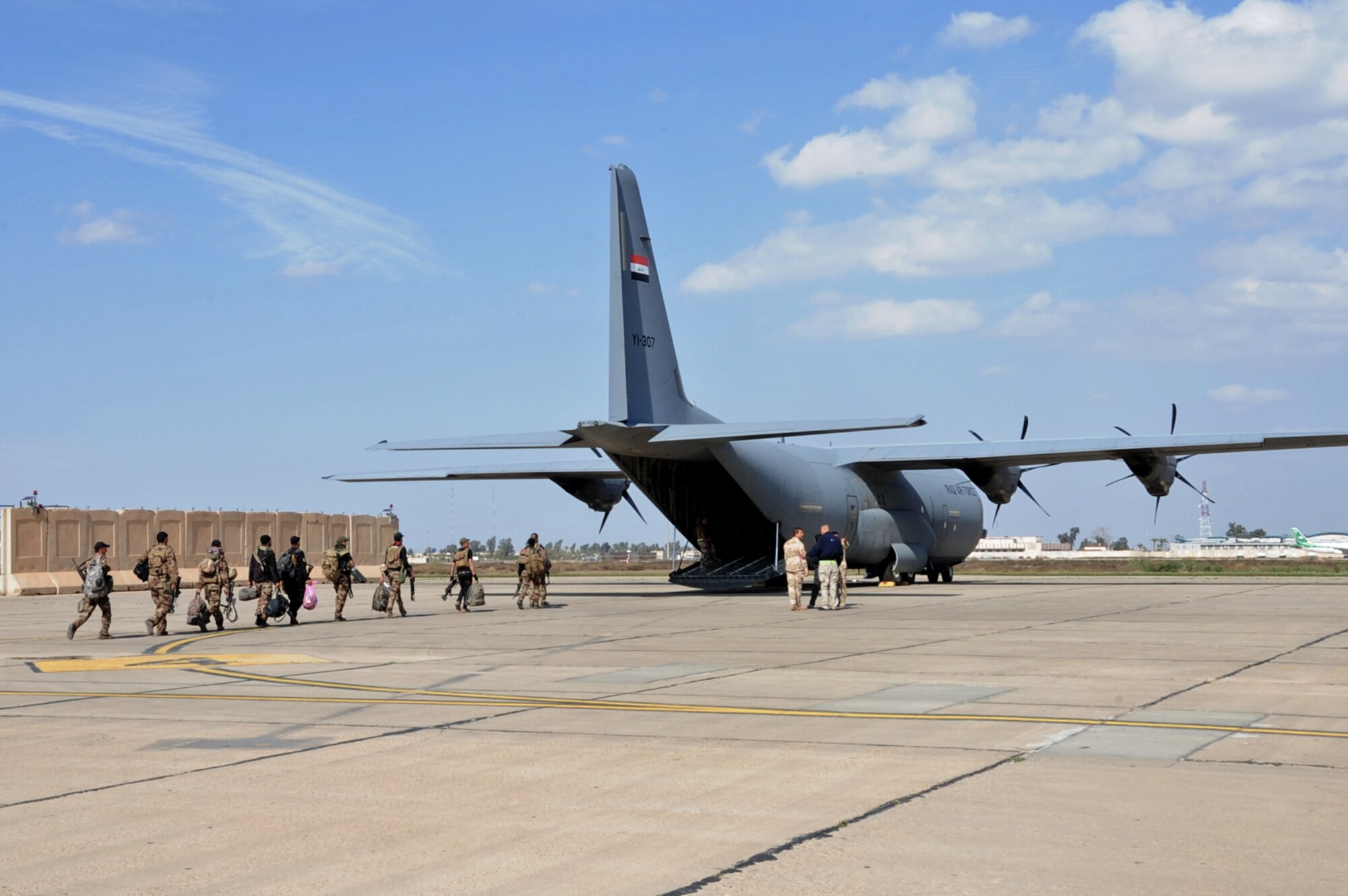 Iraqi soldiers walk onto a C-130J Super Hercules March 20, 2017 at Martyr Muhammad Alaa Air Base, Iraq. The aircraft is used by the Iraqi Air Force to transport cargo and personnel downrange in the fight against ISIS.  (U.S. Air Force photo/Tech. Sgt. Kenneth McCann)