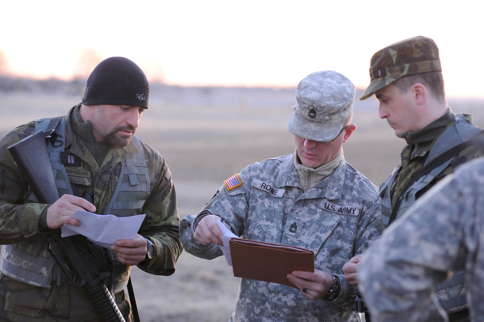 Senior Master Sgt. Karel Dostalek and Master Sgt. Vaclav Bergman, Airmen in the Czech Republic Armed Forces, get instructions from Nebraska Army National Guard Sgt. 1st Class Chad Rowe on how to maneuver the land navigation course during the state's Best Warrior competition, March 3, 2017, at Greenlief Training Site. Dostalek and Bergman were two of three Czech service members who visited Nebraska to observe and participate in the Nebraska Army National Guard’s Best Warrior competition through the State Partnership Program.