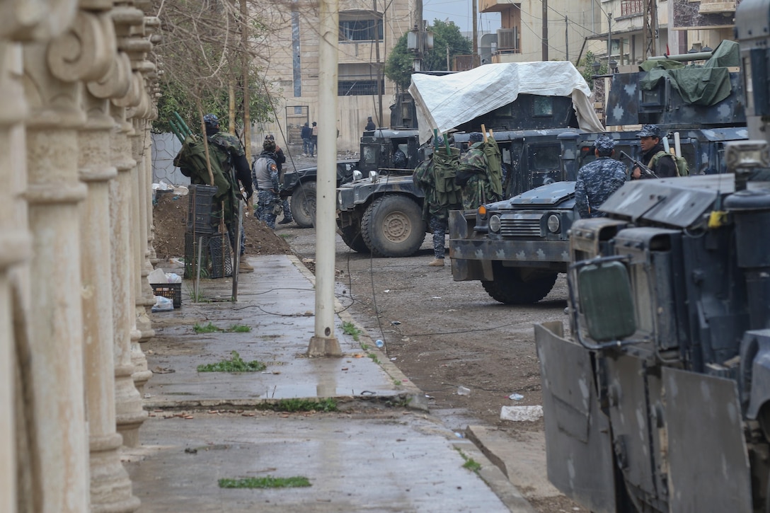 Iraqi federal police secure a city street in West Mosul, Iraq, March 2, 2017. The breadth and diversity of partners supporting the coalition demonstrate the global and unified nature of the endeavor to defeat the Islamic State of Iraq and Syria. Combined Joint Task Force Operation Inherent Resolve is the global coalition to defeat ISIS in Iraq and Syria. Army photo by Staff Sgt. Jason Hull