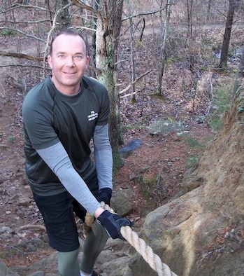 Assistant Special Agent in Charge Paul Sternal tackles the ropes on the Yellow Brick Road fitness challenge at the FBI's National Academy.
