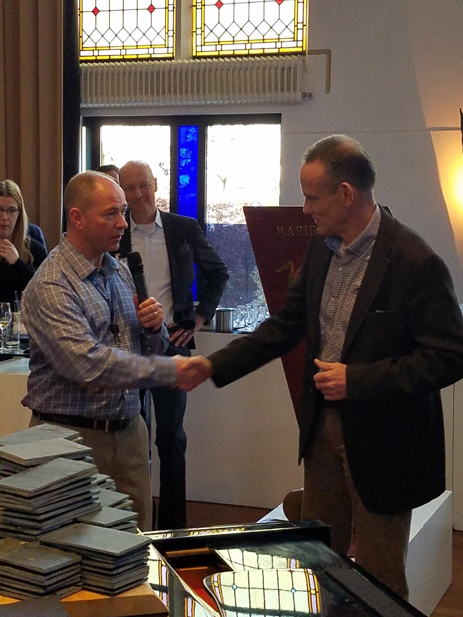 NIMBLE TITAN director Lt. Col. Joel Rousey presents Brig. Gen. R.J. Jeulink, deputy director of Plans -- Defense Staff, Ministry of Defense, Netherlands, a NIMBLE TITAN director coin following his keynote speech at the pre-conflict event in Amersfoort, Netherlands, March 13-17. 