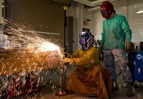 Air Reserve Technician Master Sgt. John Greene, 512th Maintenance Squadron metals technology section NCO in charge, watches Katrina Sullivan, 512th Mission Support Group honorary commander, cut through a piece of angle iron using a plasma cutter during a tour of the 436th Maintenance Group March 29, 2017, on Dover Air Force Base, Del. Twenty-three honorary commanders received mission briefings, toured various facilities and visited with Team Dover members during their one-day visit. (U.S. Air Force photo by Roland Balik)