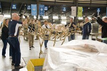 Team Dover Honorary Commanders position a cargo net over a pallet March 29, 2017, at the 436th Aerial Port Squadron on Dover Air Force Base, Del. Two teams of honorary commanders, with the help of a few Port Dawgs, competed against each other in a pallet build-up competition. (U.S. Air Force photo by Roland Balik)