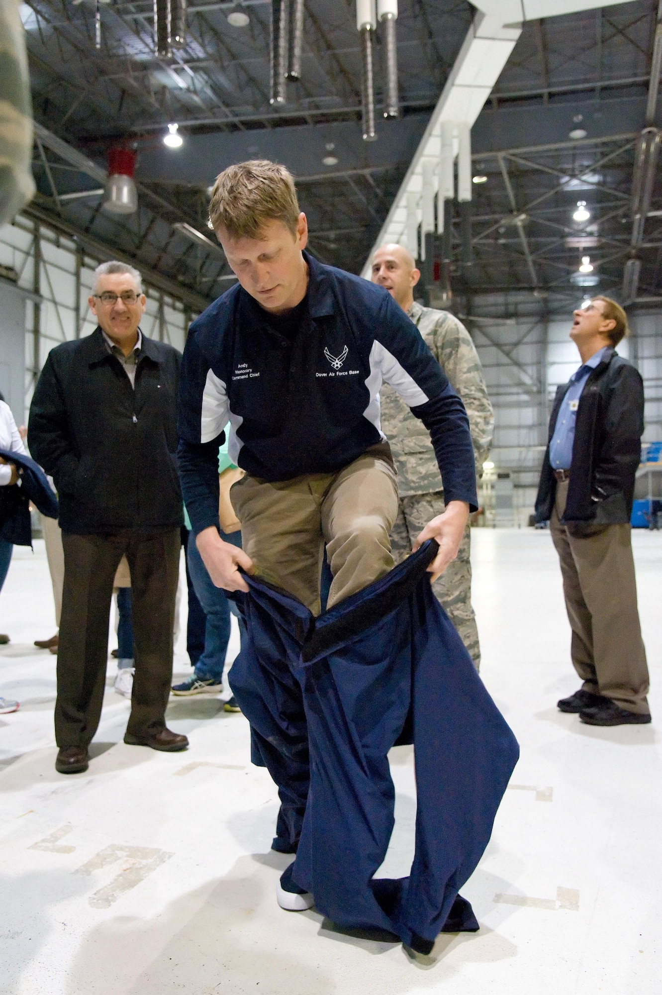 Andy Johnson, 436th Airlift Wing command chief honorary commander, puts on protective coveralls prior to entering a C-5 wing fuel tank trainer March 29, 2017, on Dover Air Force Base, Del. Johnson donned an air respirator prior to entering the trainer as if he was going to perform fuel tank maintenance or simulate being rescued during a confined area training exercise. (U.S. Air Force photo by Roland Balik)