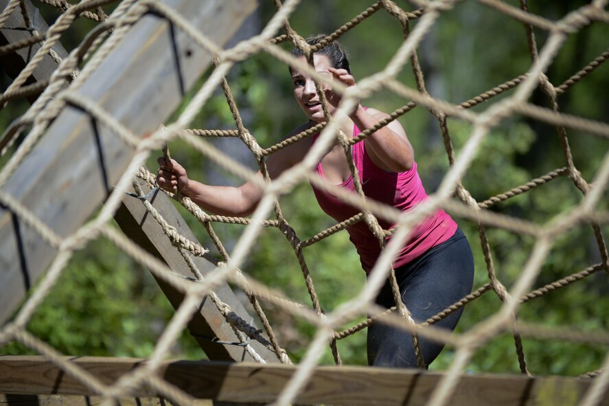 Izabela Carabelli, a participant, climbs an obstacle during the 2017 Defenders of Liberty Mud Run at Barksdale Air Force Base, La., April 1. The course was revised from previous years, adding, moving and rotating obstacles to give participants a fresh challenge. (U.S. Air Force photo/Senior Mozer O. Da Cunha)