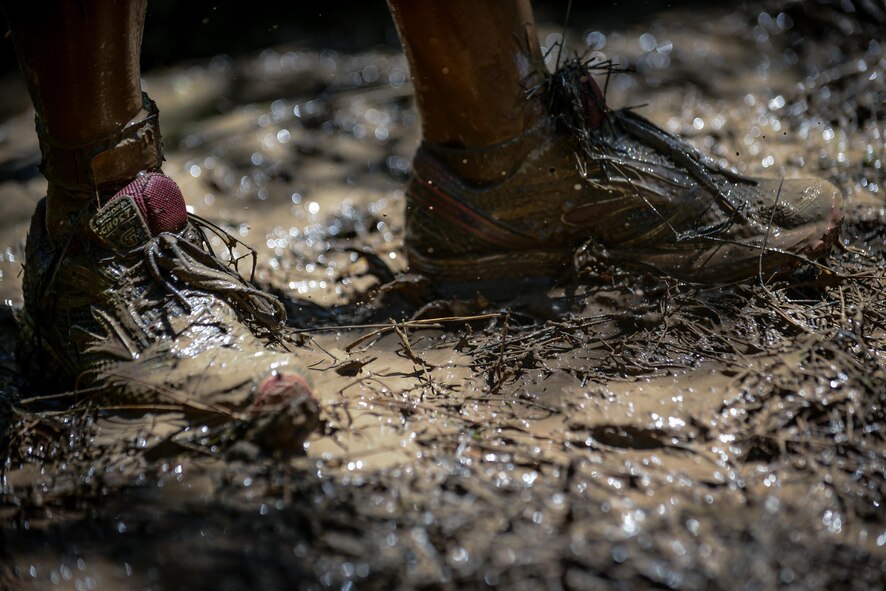 A participant catches her breath after completing a mud pit obstacle during the 2017 Defenders of Liberty Mud Run at Barksdale Air Force Base, La., April 1. Competitors tackled mud pits, barriers and other military style obstacles during the event. (U.S. Air Force photo/Senior Airman Mozer O. Da Cunha)