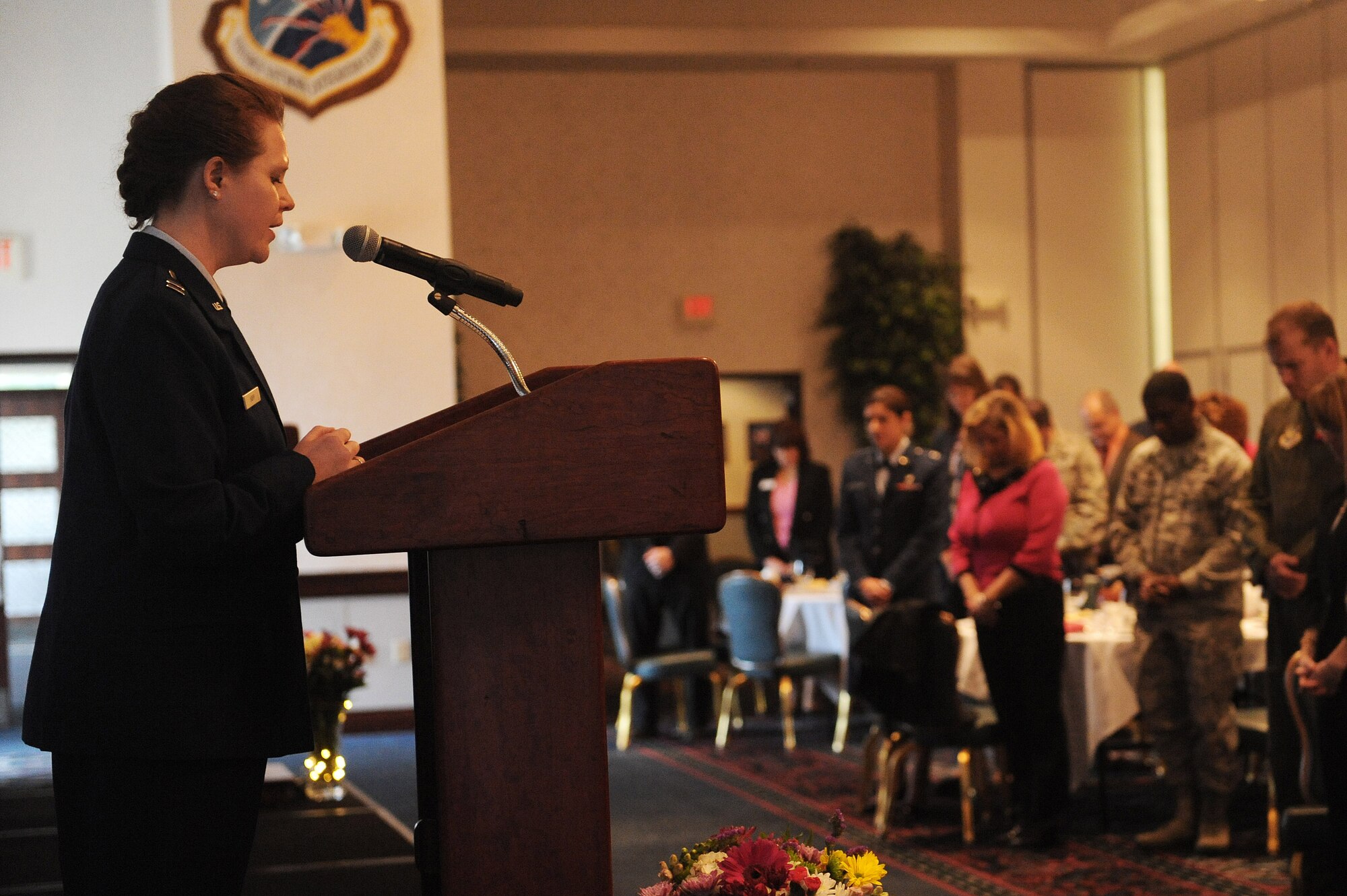 Chaplain (Capt.) Kristi Hopp, Scott Chapel, offers a prayer during a women's history luncheon at Scott Air Force Base March 29. During the history of women in the military, women could not work in all career fields. Women couldn't be chaplains until 1973. (U.S. Air Force photo by Tech. Sgt. Maria Castle)