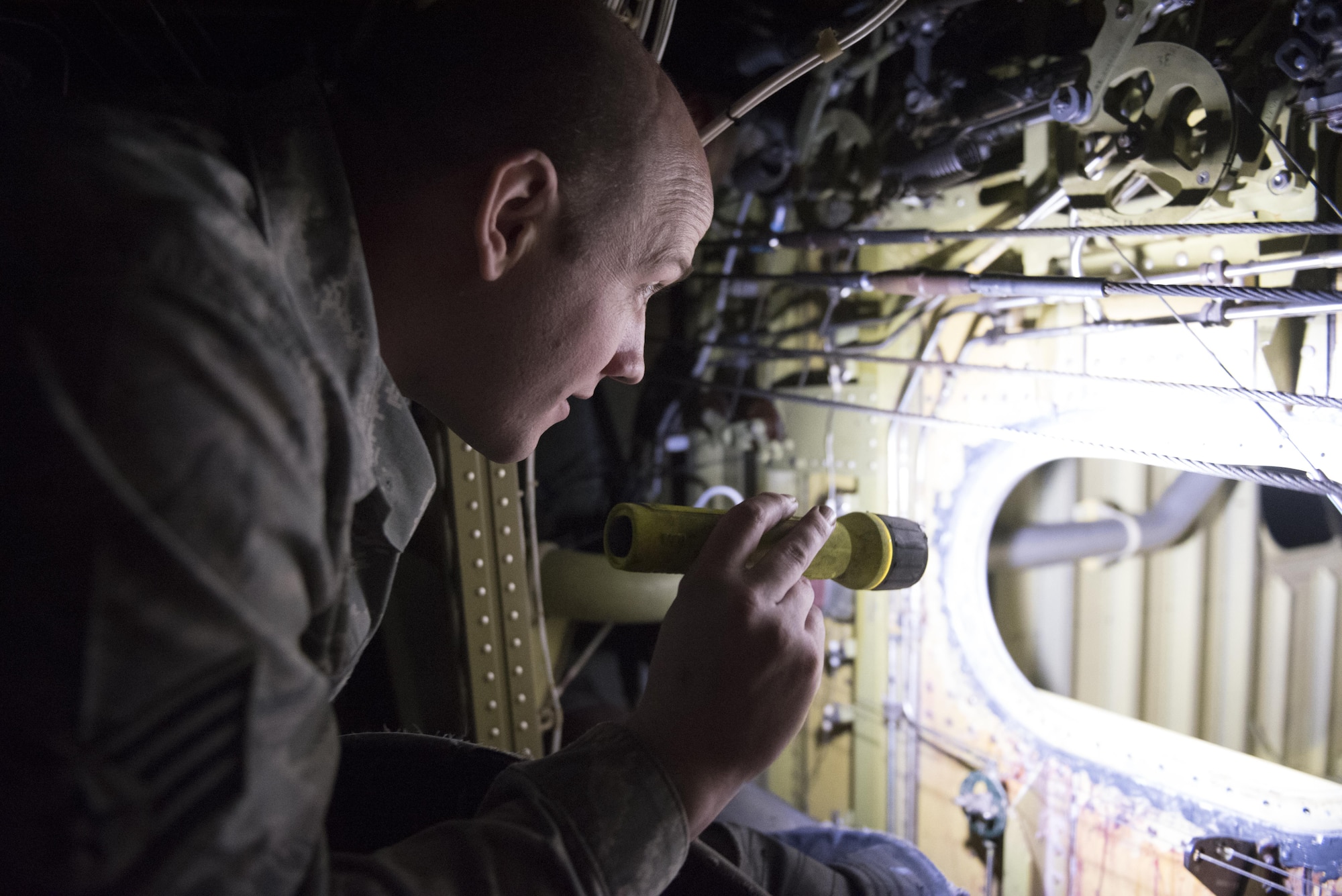 Staff Sgt. Steven Warner, 305th Maintenance Squadron Fuels Management Flight aircraft fuels system mechanic, looks into a fuel cell on a KC-10 Extneder at Joint Base McGuire-Dix-Lakehurst, New Jersey. As the airmen climb further into the fuel tank of the aircraft, the area they have  to work in becomes smaller and smaller.