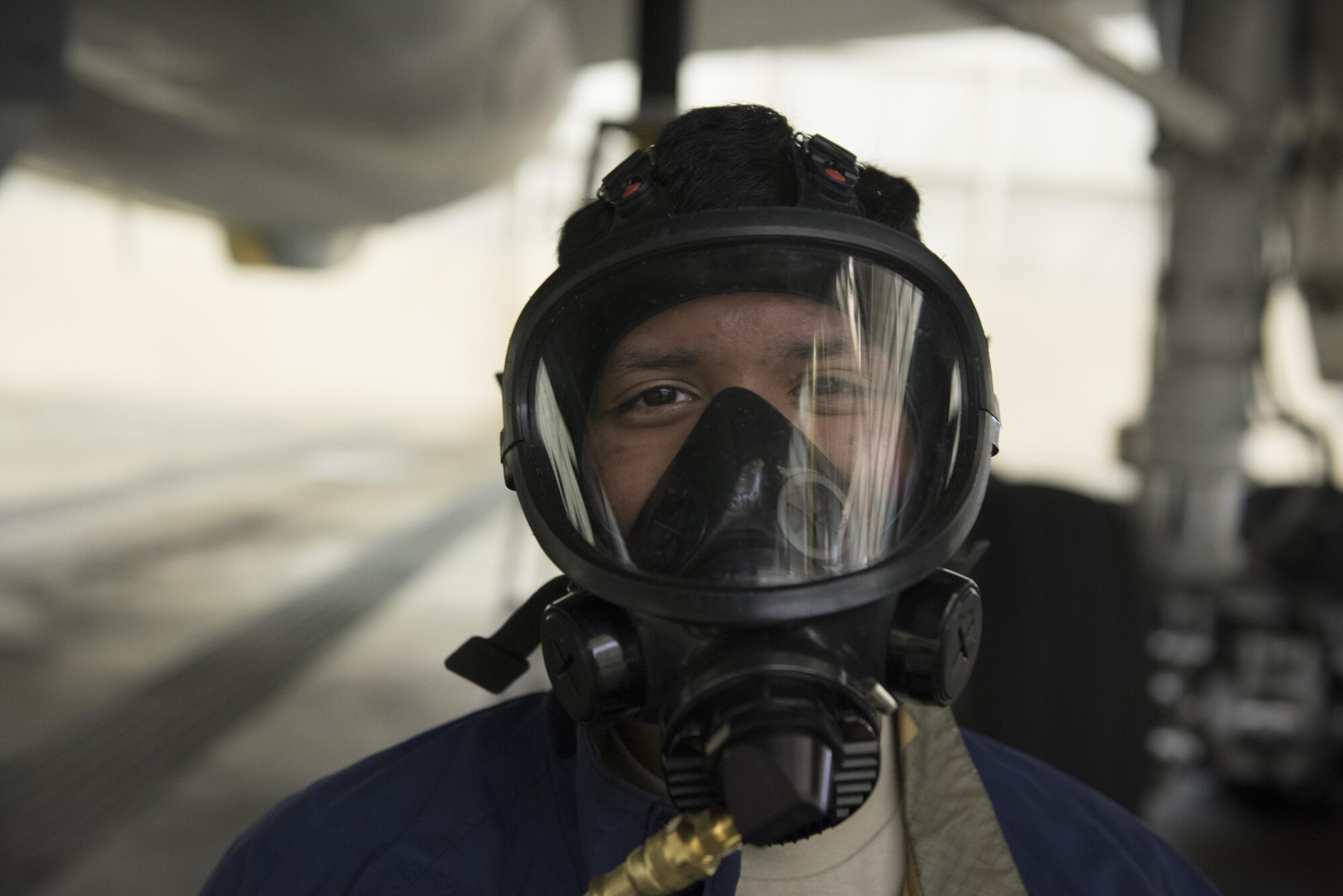 Airman 1st Class Diego Vigil-Alas, 305th Maintenance Squadron fuels system technician, suits up before entering the fuel tank of a KC-10 Extender at Joint Base McGuire-Dix-Lakehurst, New Jersey, April 5, 2017. Outside Air is pumped in through a series of compressors before being pumped into the mask to prevent flammable gases from forming.