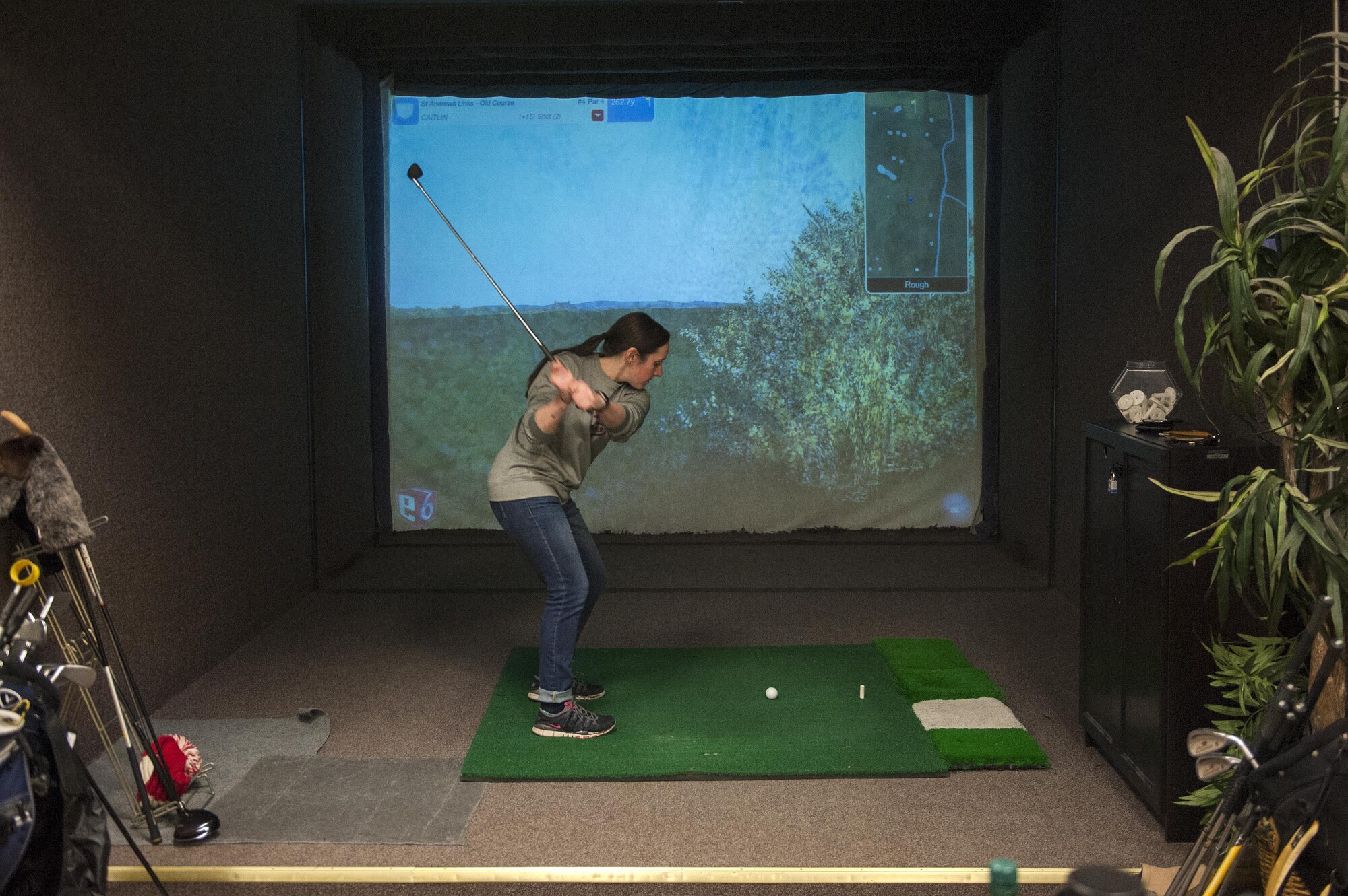 U.S. Air Force Airman 1st Class, Caitlin Oleska, Signals Analyst with the 301st Intelligence Squadron, plays a round of golf on the golf simulator at Arctic Oasis, March 31, 2017, Joint Base Elmendorf-Richardson, Alaska. Due to the accumulation of snow and ice during the winter, the golf season is limited to only 5-6 months. 